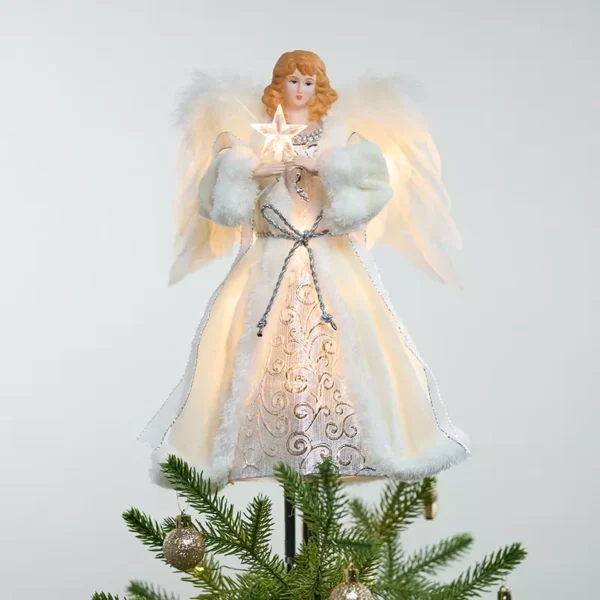 A lighted white angel tree topper on top of the Christmas tree