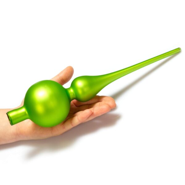 A man holds an apple green glass spherical finial tree topper
