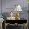 The display effect of gold guardian angel statue on a bedside table