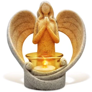 There is a praying angel statue candle holder on a white background