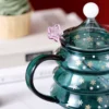 The details of Christmas tree wine glass coffee mug with lid and straw spoon on the table