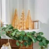 There are 3 champagne gold mercury finish glass Christmas tree on the chimney.