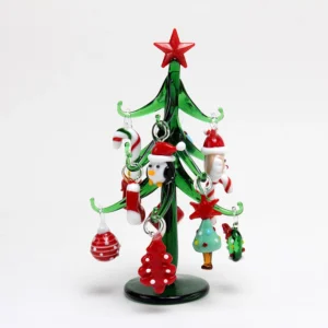 There is a green glass Christmas tree on the white background