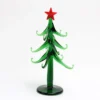 There is a green glass Christmas tree without ornaments