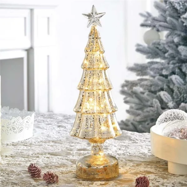 The mercury glass Christmas tree mini tabletop decoration glowing on a Christmas table