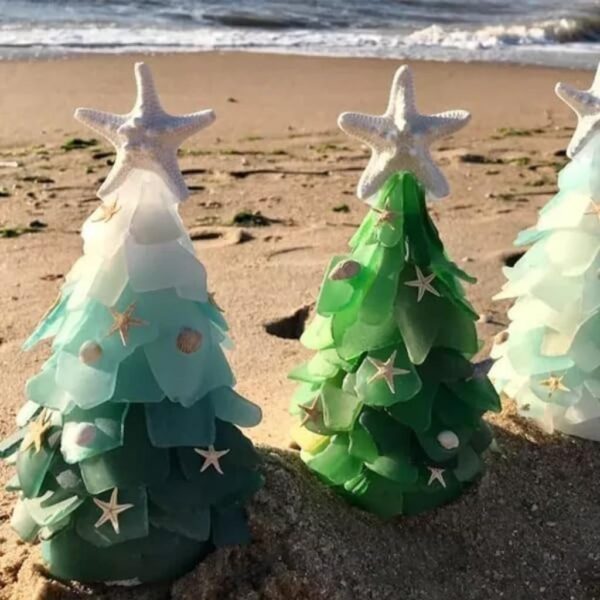 There are three sea glass Christmas tree besides the beach