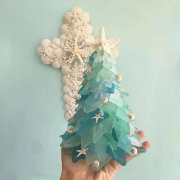 A man holds the sea glass Christmas tree