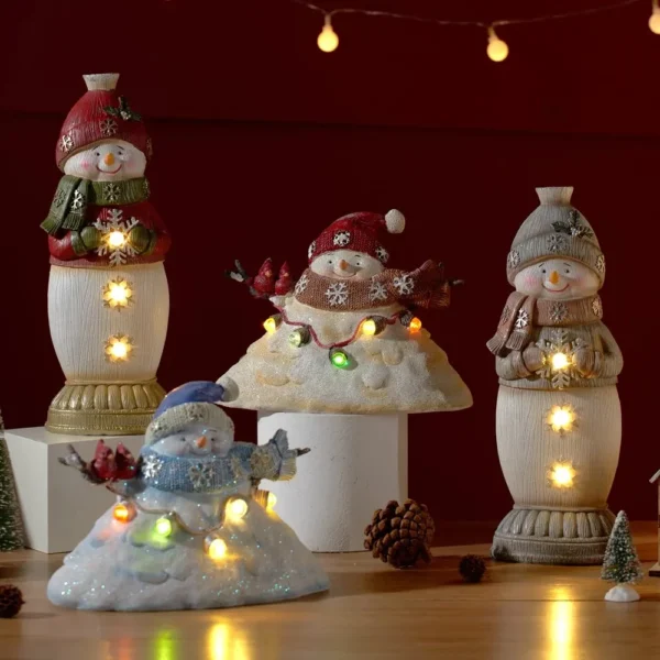 Four glowing Snowman Christmas ornaments LED lighted resin figurines