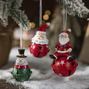 Three painted jingle bell Christmas ornaments hanging on the Christmas tree
