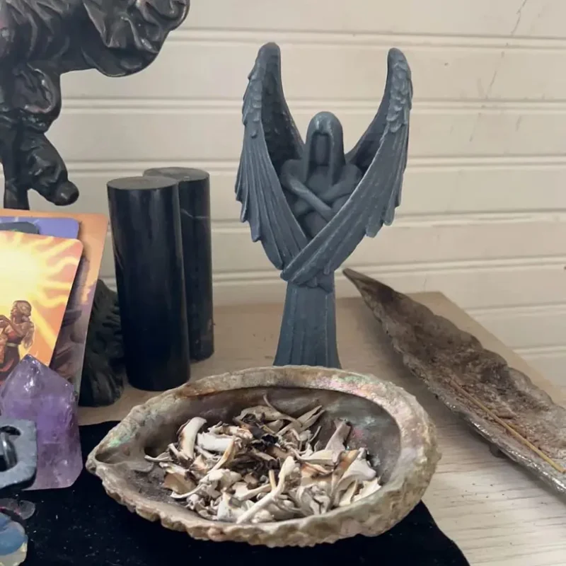 There is a black fallen angel statue on the altar