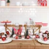 There are some red and white Christmas ball decorations on the tableware