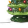 There is an electric wire installed at the bottom of the ceramic Christmas tree