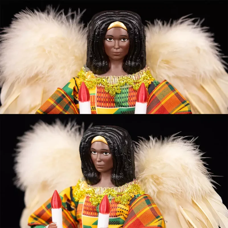 The face of the black woman angel tree topper dressed with kente cloth