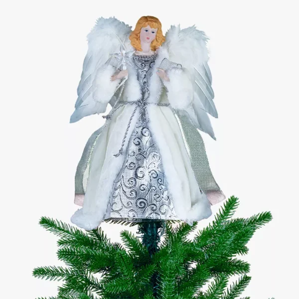 A silver angel Christmas tree topper on top of a Christmas tree