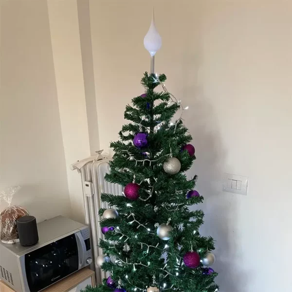 There is a bright one ball finial tree topper on the top of a Christmas tree