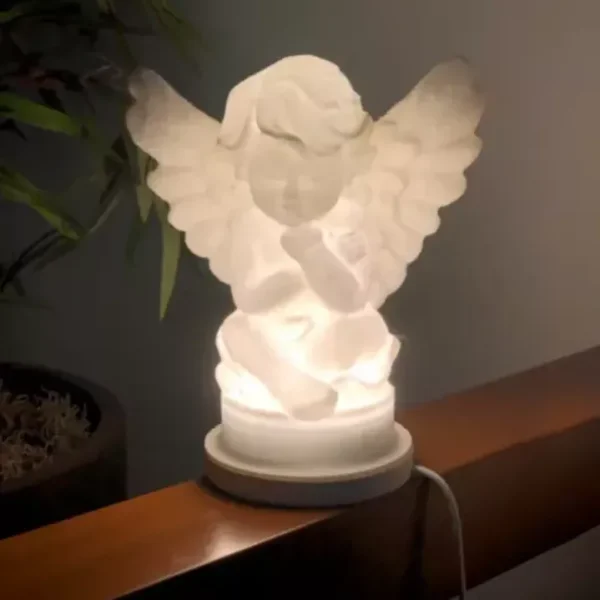 There is a lighting Cherub angel figurine on the shelf