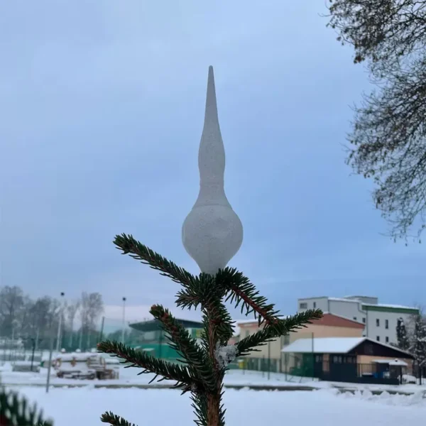 A finial dabra tree topper on top of a Christmas tree