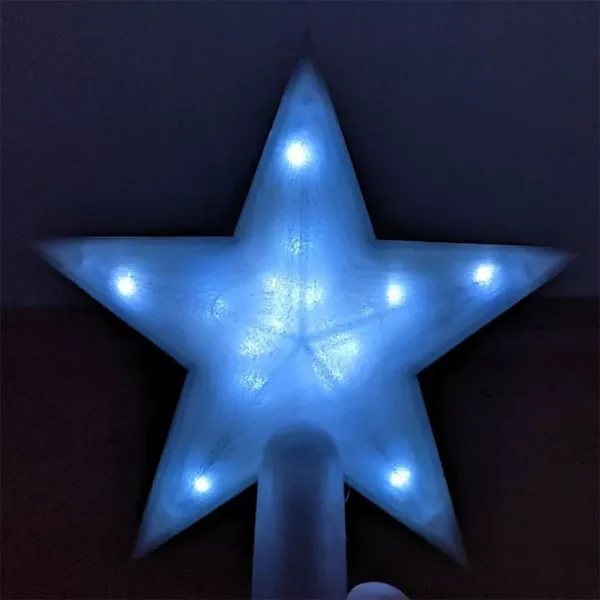 A blue LED lighted star Christmas tree topper in the dark