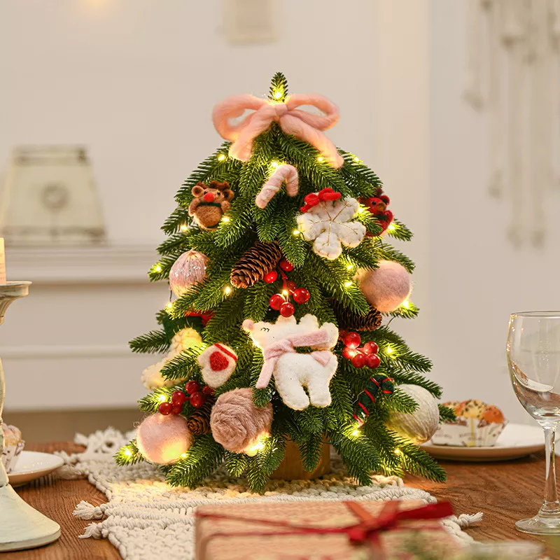 A lighted decorated mini table Christmas tree