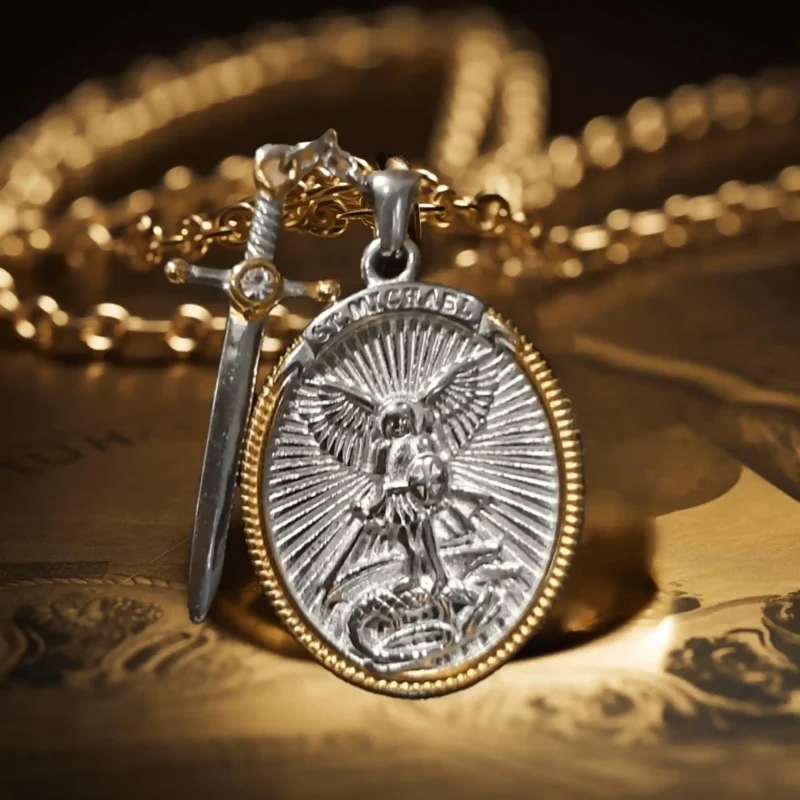 A St Michael oval-shaped pendant with a divine sword stands on the table.