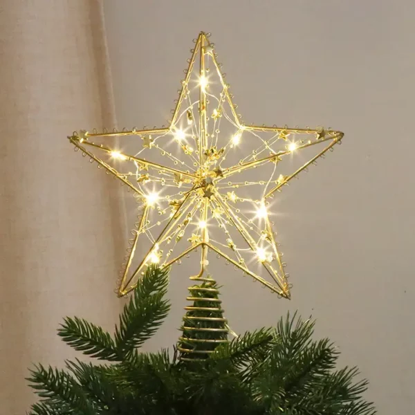 A gold star Christmas tree topper stands on the tree.