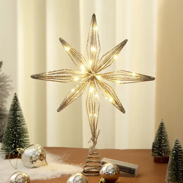 A gold hollow star tree topper stands on the table.