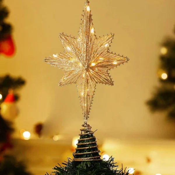 A glitter star tree topper stands on a Christmas tree.