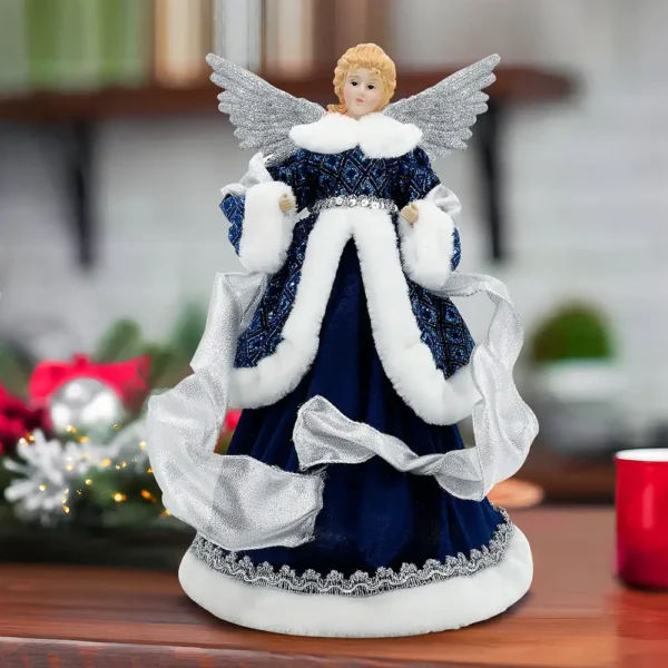 An angel tree topper with silver wings stands on the table.