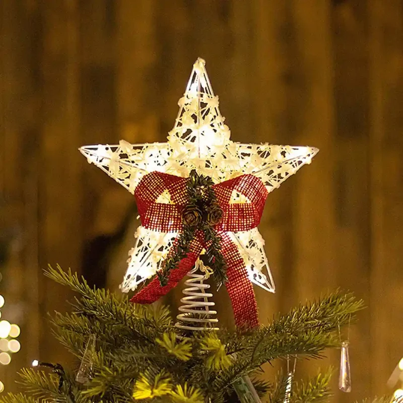 A lighted 3D warm light star tree topper firmly stands on the tree.