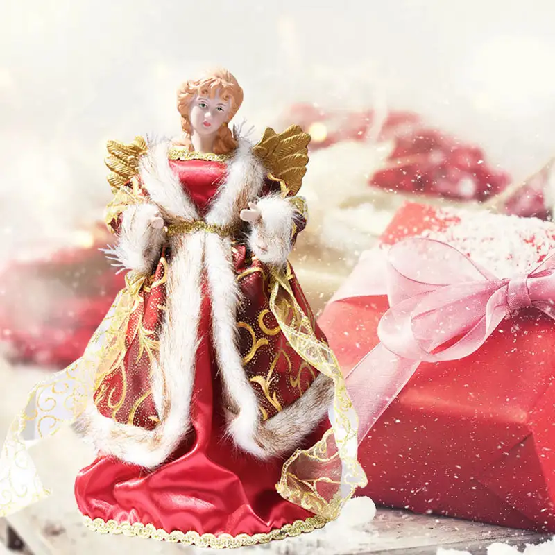 An angel tree topper with golden wings stands on the table.