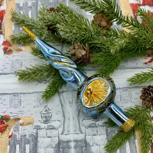 A small finial tree topper is lying on the table.