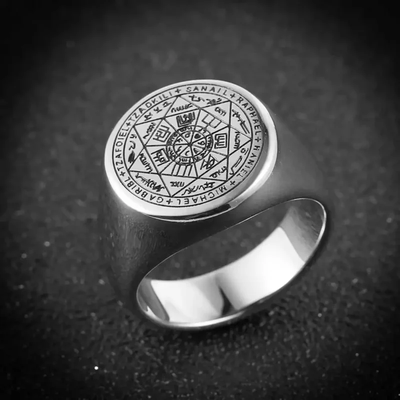 A silver ring stands on the ground.