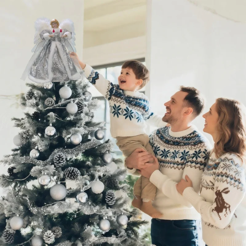 Heartwarming Christmas moment: father helps boy put angel tree topper while mother looks on smiling