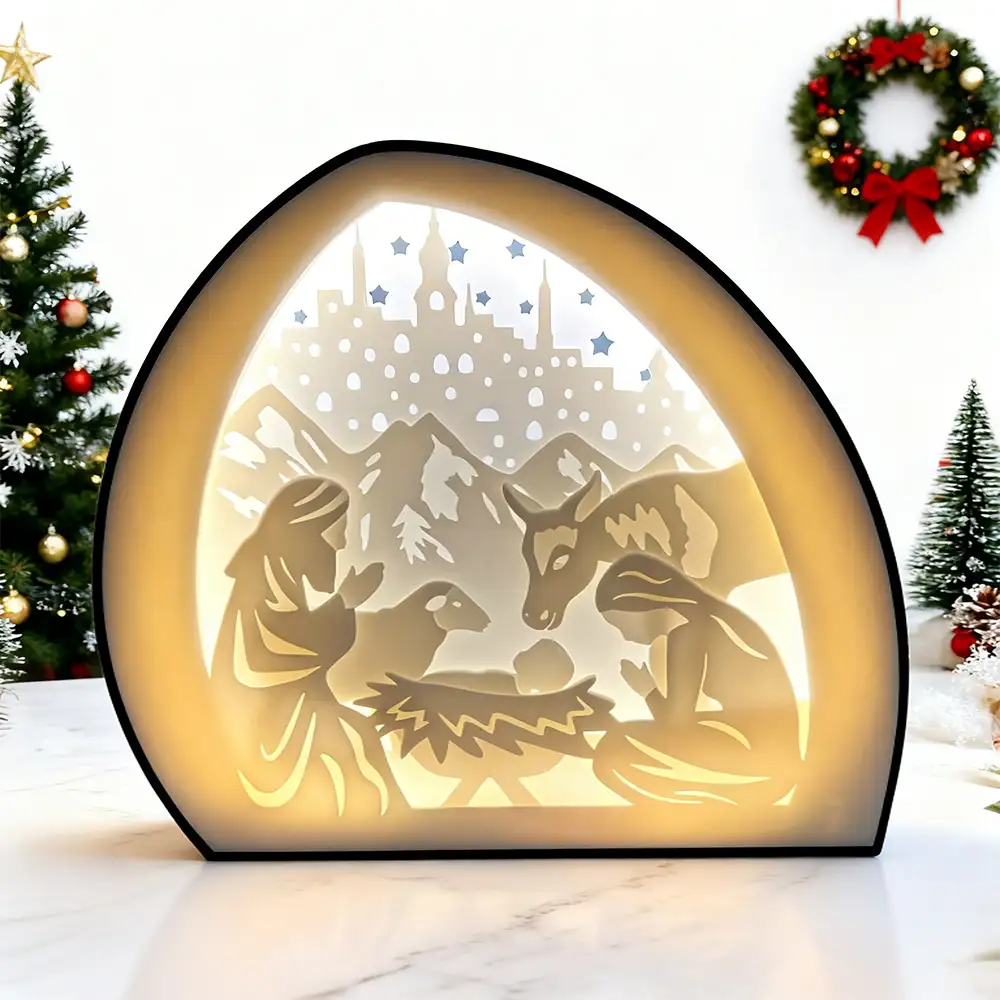 A light-up nativity shadow box is on the table.