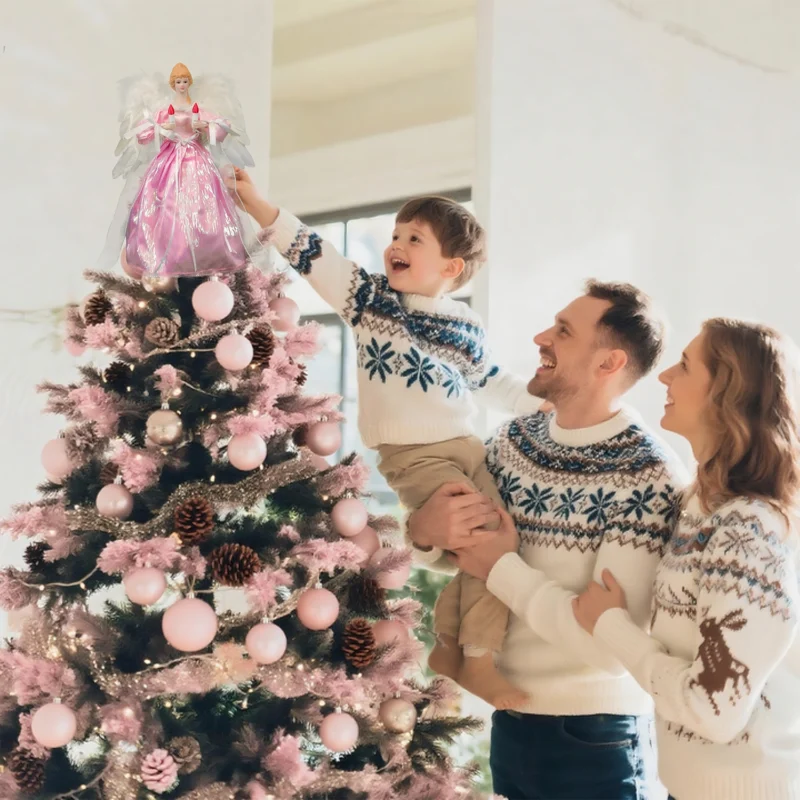 Heartwarming Christmas moment: father helps boy put angel tree topper while mother looks on smiling