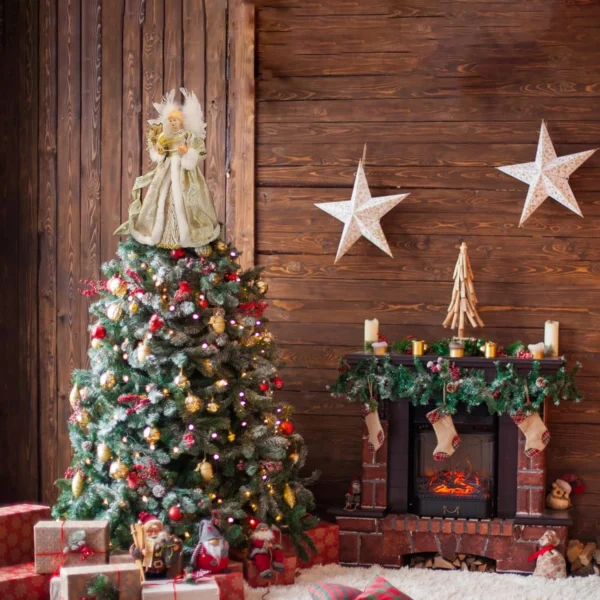 The vintage gold angel Christmas tree topper on top of a Christmas tree